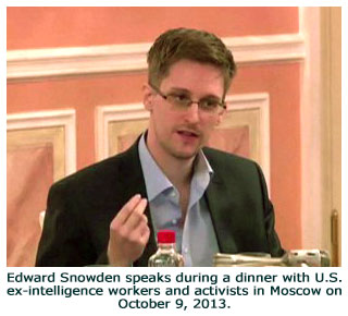 Edward Snowden speaks during a dinner with U.S. ex-intelligence workers and activists in Moscow on October 9, 2013